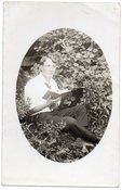 Image of DREAMY MAN READS A BOOK IN THE GRASS REAL PHOTO POSTCARD