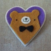 Image of mustard pudgy bear + bowtie heart