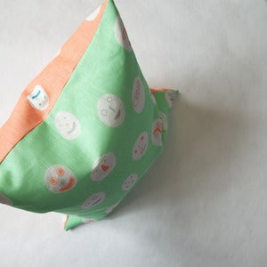 Image of Masks cushion - peppermint & coral