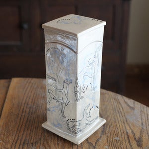 Image of Tall box with Greyhounds and rabbits in black and light blue