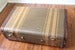 Image of Vintage Suitcase Luggage. Brown, striped with leather trim.