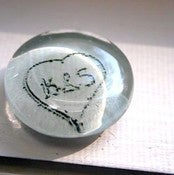 Image of Tiding Magnet. A Photograph of Your Name or Initials in Sand, Encased in a Glass Magnet.